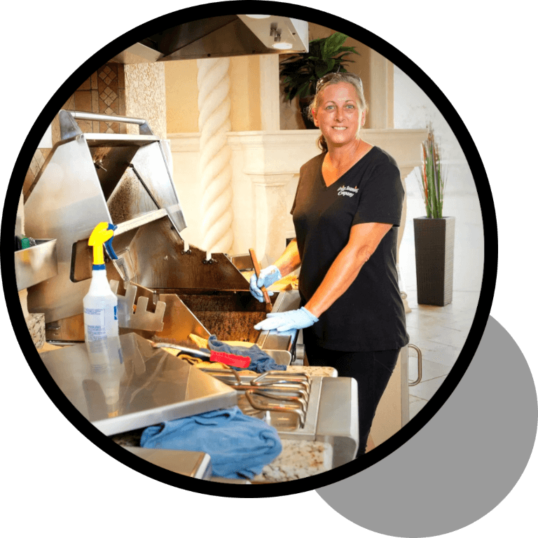 A woman in black shirt and blue gloves cooking food.