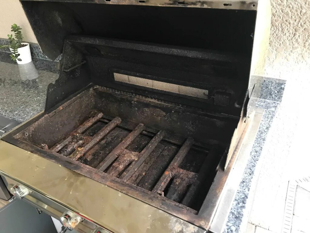 A grill that has been burned and is open.