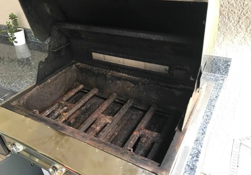 A grill that has been burned and is open.
